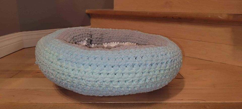 A light blue crochet mat.